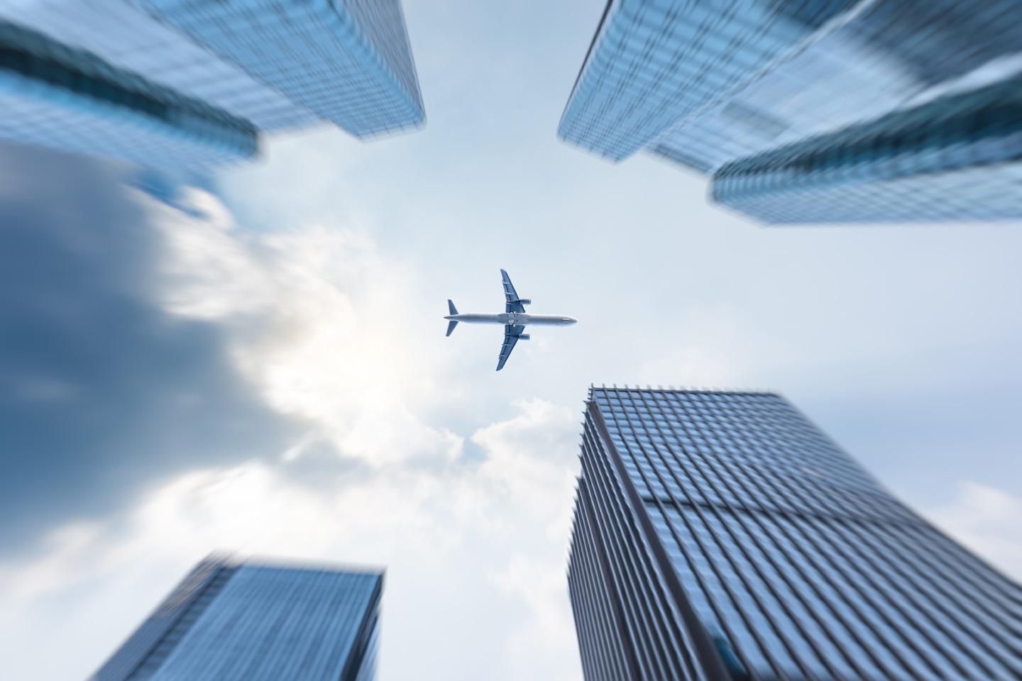 plane-flying-skyscrapers-low-angle-global-travel
